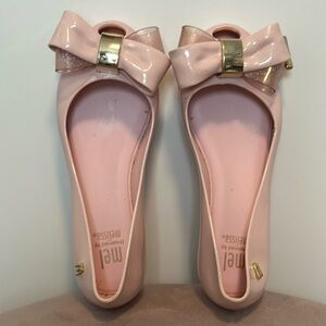 Beautiful blush, pink, mini Melissa with pink and gold accent bow in size 12!